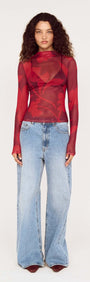 Model wearing an Oversized Floral High Neck Mesh Top paired with wide-leg jeans.