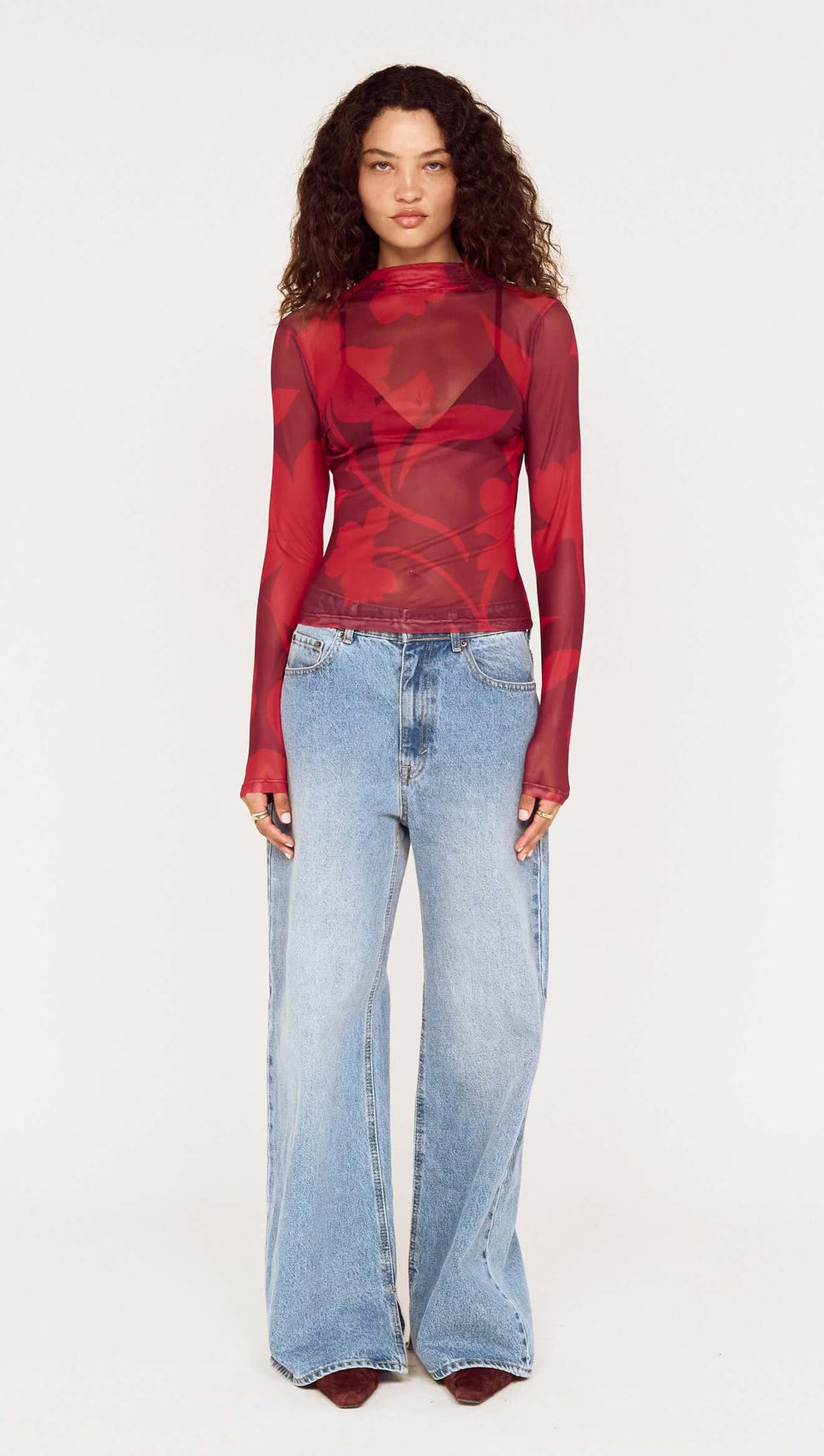 Model wearing an Oversized Floral High Neck Mesh Top paired with wide-leg jeans.