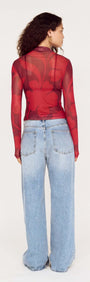 Back view of a model wearing an Oversized Floral High Neck Mesh Top paired with baggy denim jeans.