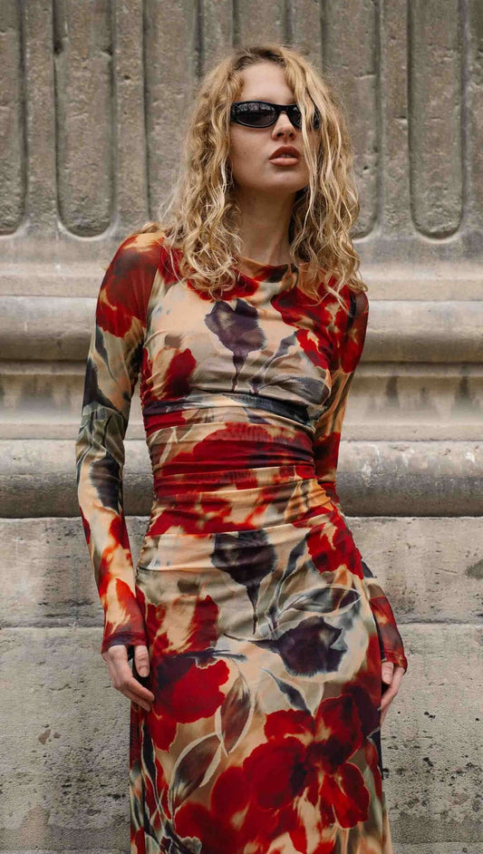 Red Floral Sheer Mesh Midi Dress featuring a model with sunglasses standing against a textured stone background.