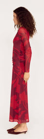 Woman wearing an Oversized Floral Mesh Midi Dress with Gather Detail in red, showcasing a side view of the elegant design.