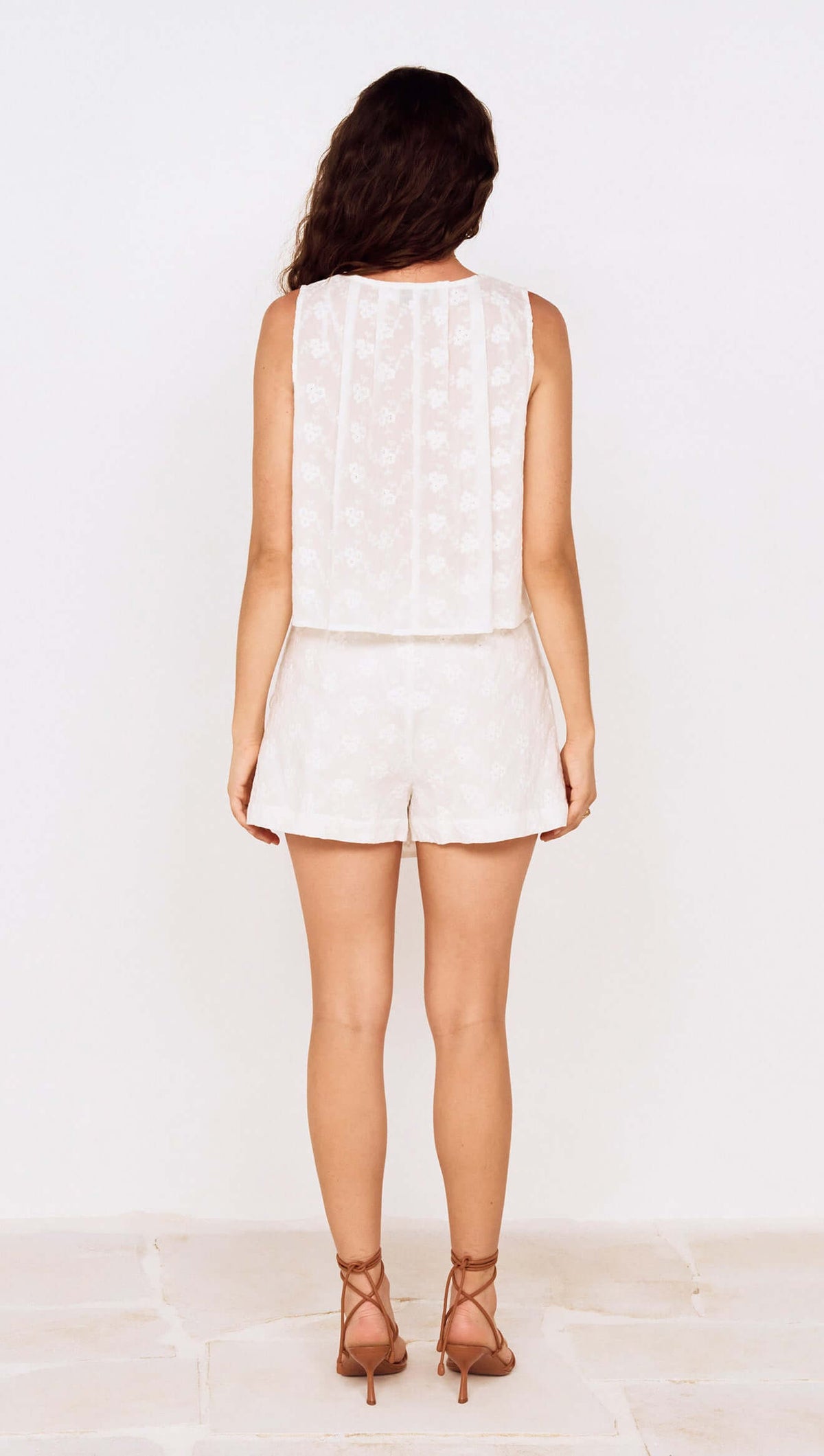 Model showcasing the back view of the Tie Detail Broderie Anglaise Cotton Skort outfit.