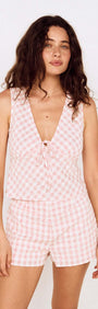 Model wearing a Pink Gingham Cotton Top with Tie Detail and matching shorts, showcasing a playful summer look.