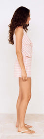 Profile view of a model wearing Pink Gingham Cotton Baby Shorts with matching top, featuring a relaxed fit and elastic waistband.