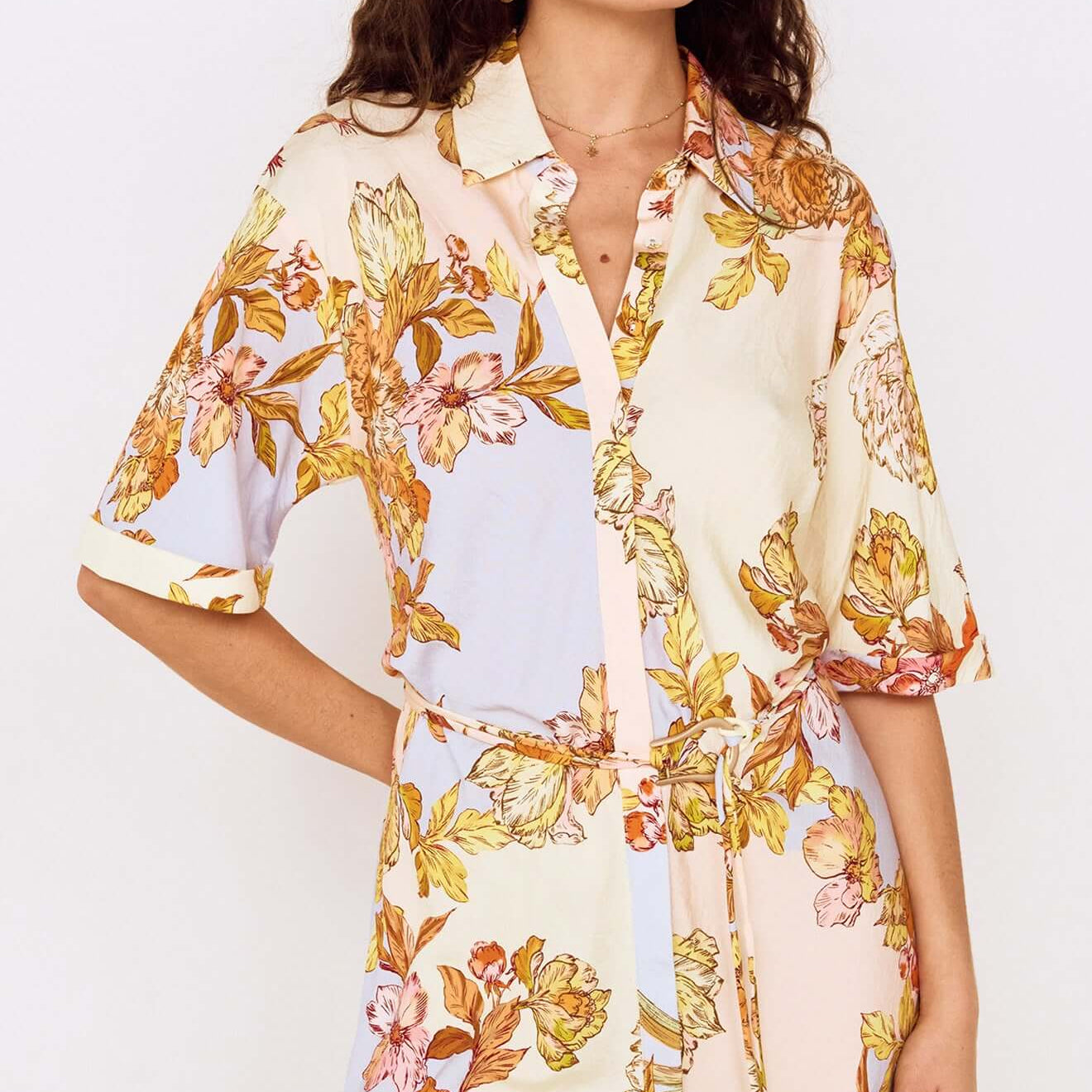 Woman wearing a stylish Pastel Floral Mini Shirt Dress with oversized florals and a collared neckline.