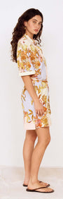 Pastel Floral Mini Shirt Dress worn by a model showcasing a side view of the garment with floral print design.