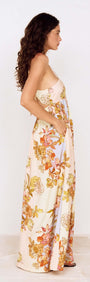 Pastel Floral Tie Detail Maxi Dress worn by a model, showcasing its floral print and flowing silhouette from the side.