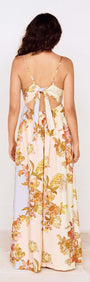 Back view of the Pastel Floral Tie Detail Maxi Dress with a floral print and open tie-back detail.