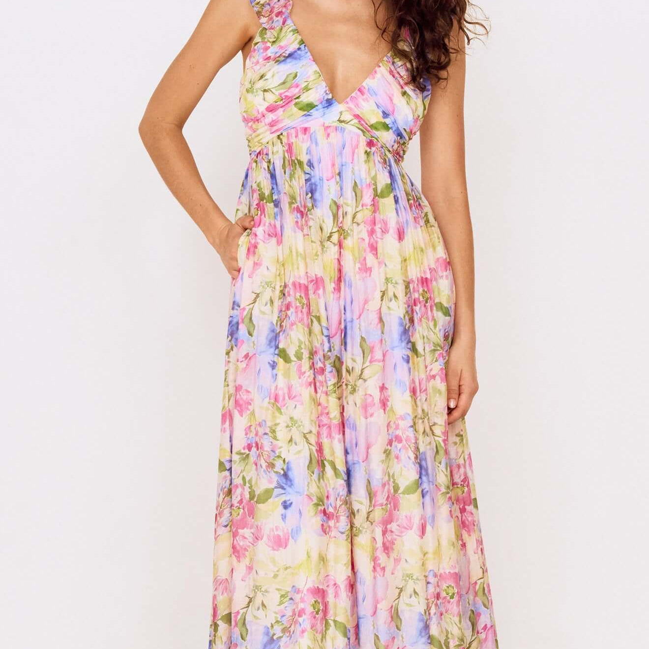 Model wearing a Watercolour Floral Ruffle Maxi Dress featuring a pastel floral print and ruffle shoulder straps.
