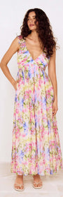 Model wearing a Watercolour Floral Ruffle Maxi Dress featuring a pastel floral print and ruffle shoulder straps.