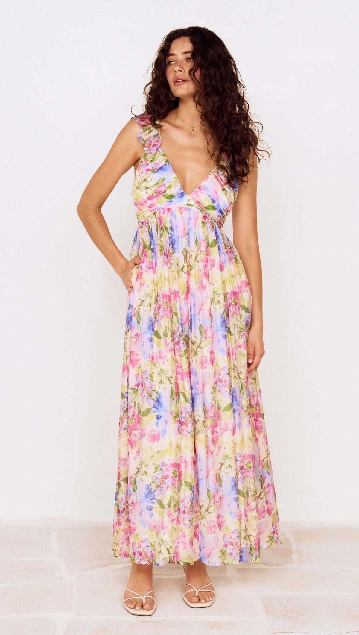 Model wearing a Watercolour Floral Ruffle Maxi Dress featuring a pastel floral print and ruffle shoulder straps.