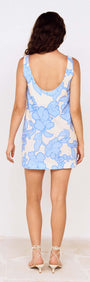 Back view of Blue Floral Print Mini Shift Dress featuring a light blue floral design on a cream background.