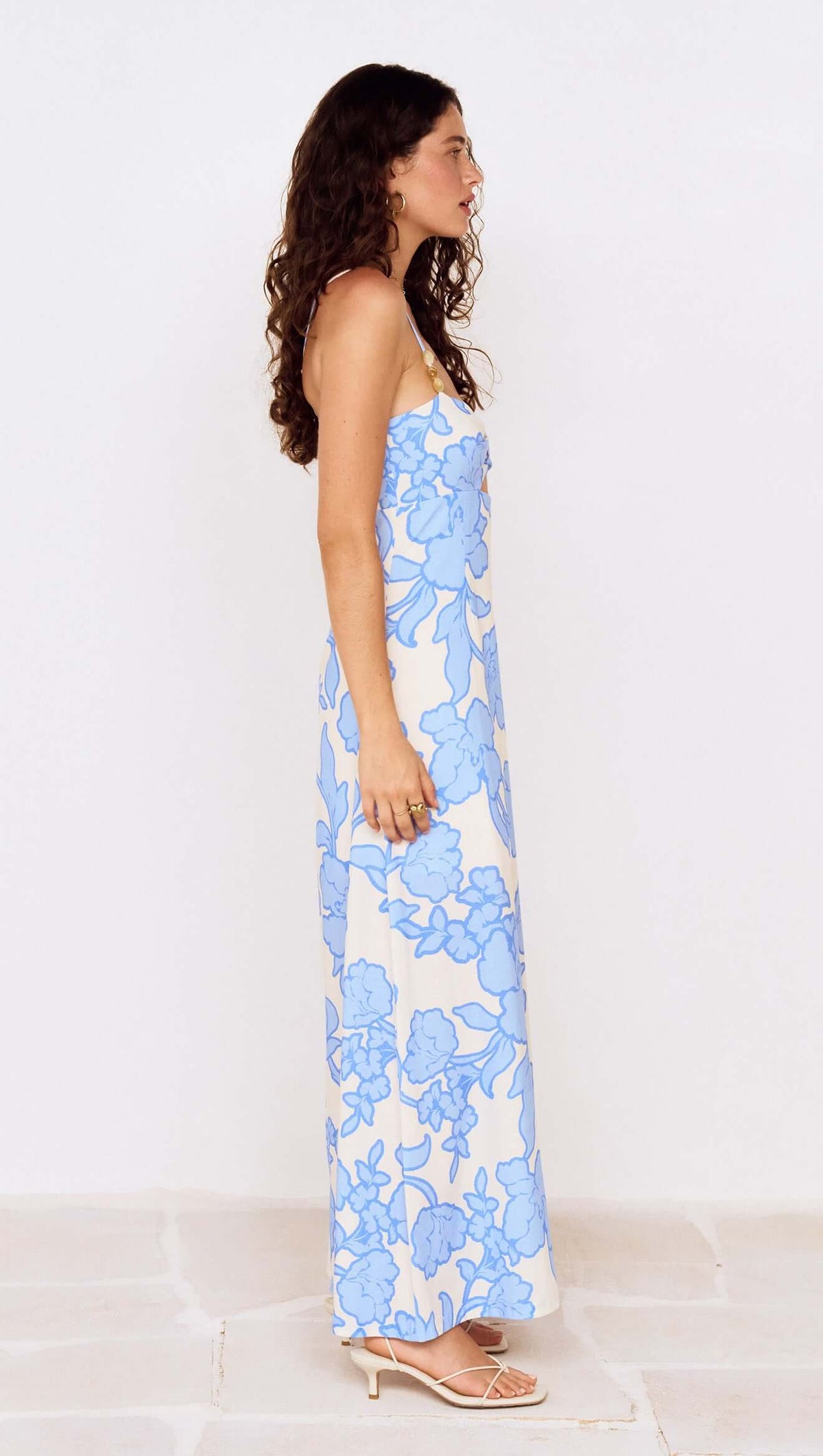 Blue Floral Twist Front Maxi Dress with Side Split showcased on model in profile view.