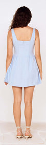 Back view of a model wearing a Baby Blue Square Neck Mini Dress, showcasing its stylish fit and flared skirt.