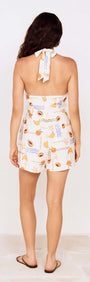 Back view of a woman wearing a Fruit Print Halter Neck Romper with a vibrant fruit-inspired print.