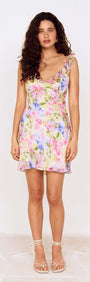 Watercolour Floral Mini Dress with Frill Trim modeled by a woman with curly hair, showcasing a soft and romantic style.