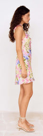 Side view of Watercolour Floral Mini Dress with Frill Trim, showcasing a colorful floral pattern and frill detail.