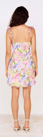 Back view of Watercolour Floral Mini Dress with Frill Trim featuring colorful floral design and adjustable straps.