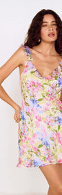 Watercolour Floral Mini Dress with Frill Trim worn by a model, featuring a floral pattern and delicate frill sleeves.