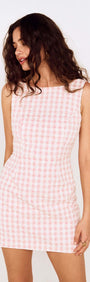 Model wearing a Pink Gingham Tie Back Cotton Mini Dress with a fitted silhouette and open back design.