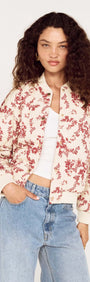 Model wearing the Autumn Floral Quilted Puffer Jacket with a floral pattern and casual jeans, showcasing a stylish fall look.