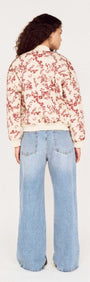 Back view of a model wearing the Autumn Floral Quilted Puffer Jacket paired with wide-leg jeans.