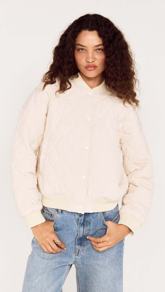 Quilted Bomber Jacket in Warm White worn by model, featuring a relaxed silhouette and classic bomber shape.