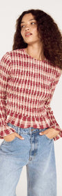 Model wearing a Frill Detail Check Print Shirred Top paired with denim jeans, showcasing a stylish, casual look.