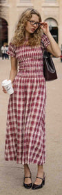 Short Sleeve Shirred Check Midi Dress worn by a woman holding a coffee cup in a park setting with stylish accessories.