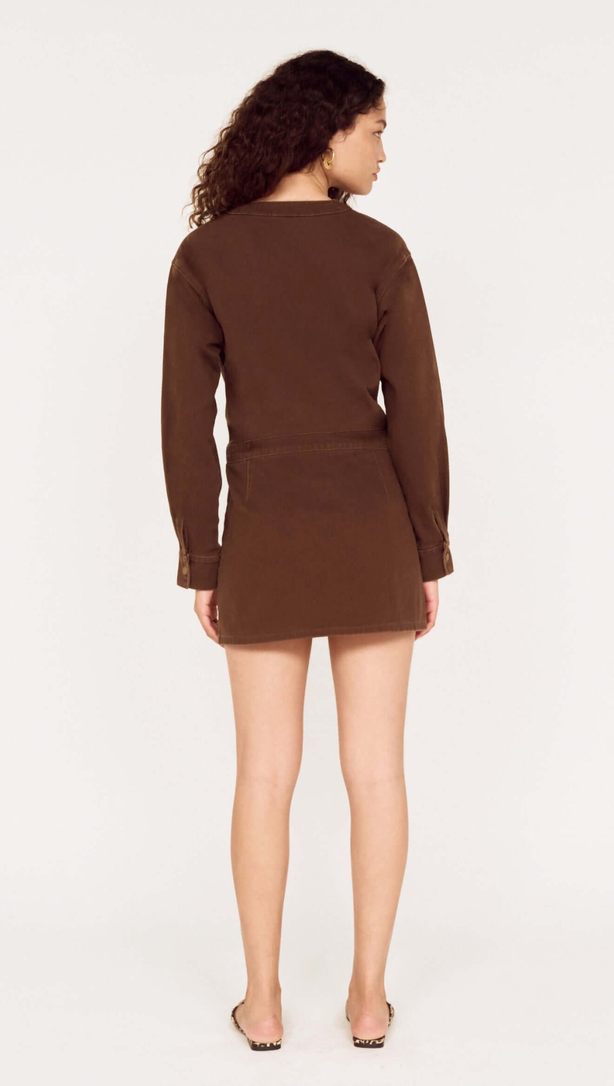 Back view of a model wearing a Brown Denim Wrap Mini Dress, showcasing the style and fit.