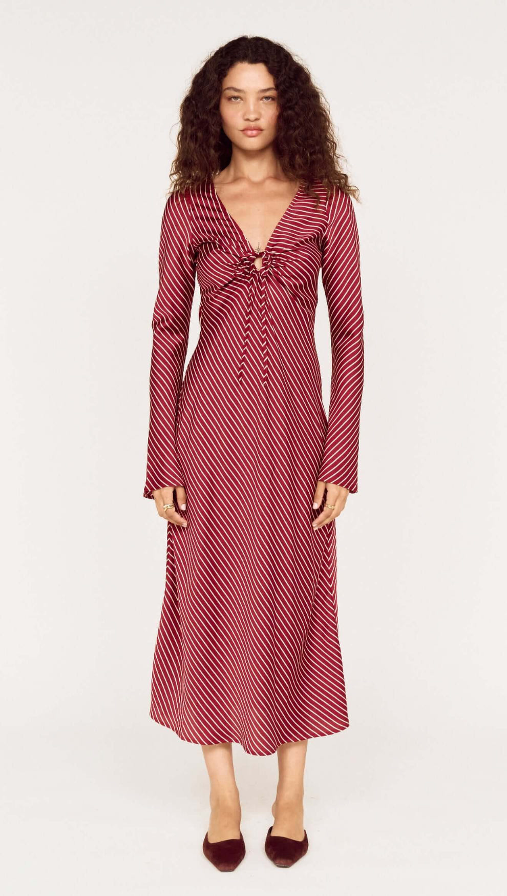 Burgundy Pinstripe Bias Cut Midi Dress worn by a model, featuring a plunging V-neckline and tie-front detailing.