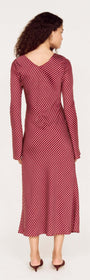 Rear view of a woman wearing the Burgundy Pinstripe Bias Cut Midi Dress with flared sleeves and a flowing silhouette.