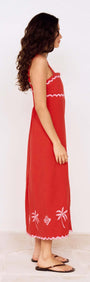 Side view of a model wearing a Red and Pink Embroidery Detail Midi Dress with palm embroidery and adjustable straps.