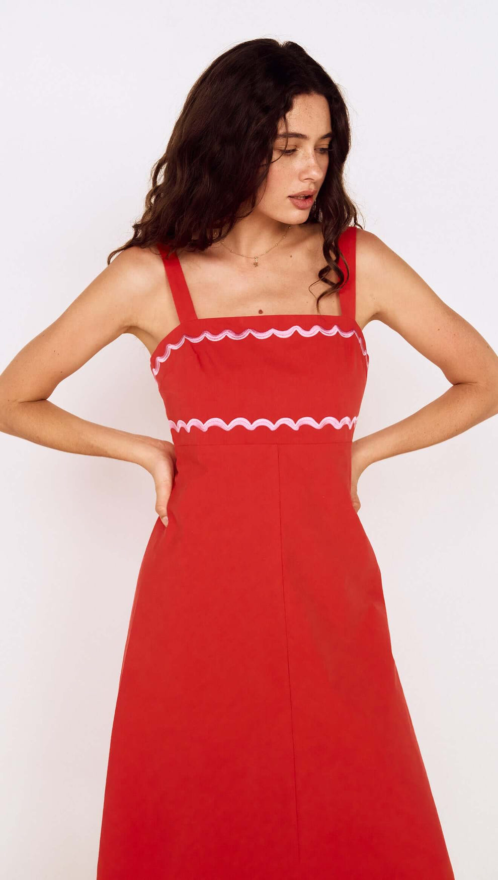 Model wearing a Red and Pink Embroidery Detail Midi Dress with scalloped neckline and straps.