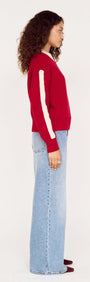 Relaxed Red Contrast Stripe Jumper featuring a bold red color with white stripe details, styled with high-waisted jeans.
