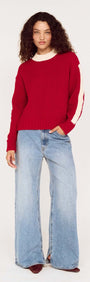 Model wearing the Relaxed Red Contrast Stripe Jumper with wide-leg jeans, showcasing a sporty look and comfortable fit.