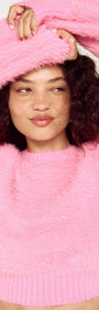 Clio Cropped Fuchsia Pink Fluffy Jumper modeled by a woman with curly hair, showcasing the soft texture and vibrant color.