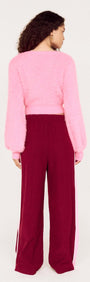 Clio Cropped Fuchsia Pink Fluffy Jumper worn with matching maroon pants, showcasing a back view of the stylish outfit.