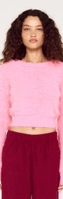 Clio Cropped Fuchsia Pink Fluffy Jumper worn by model with curly hair, showcasing a vibrant, soft knit texture.