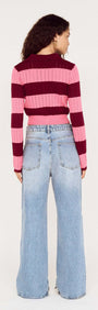 Back view of a model wearing a Pink Stripe Pointelle Knit Cardi with wide-leg jeans.