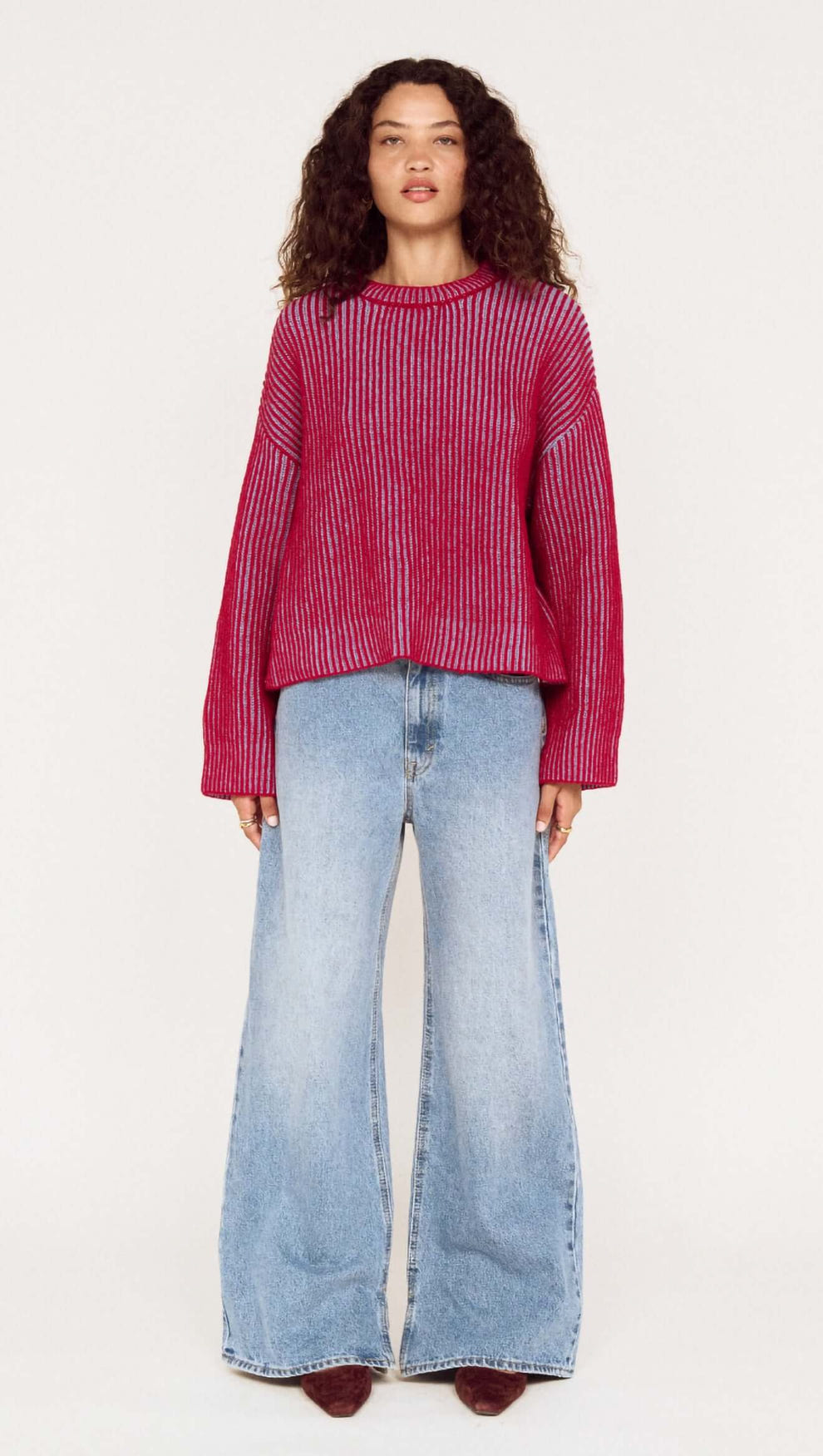 Model wearing Blue and Berry Contrast Rib Knit Jumper with flared jeans, showcasing a stylish two-tone knitwear look.