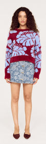 Model wearing the Intarsia Floral Soft Touch Jumper paired with a denim skirt, showcasing the vibrant floral design.