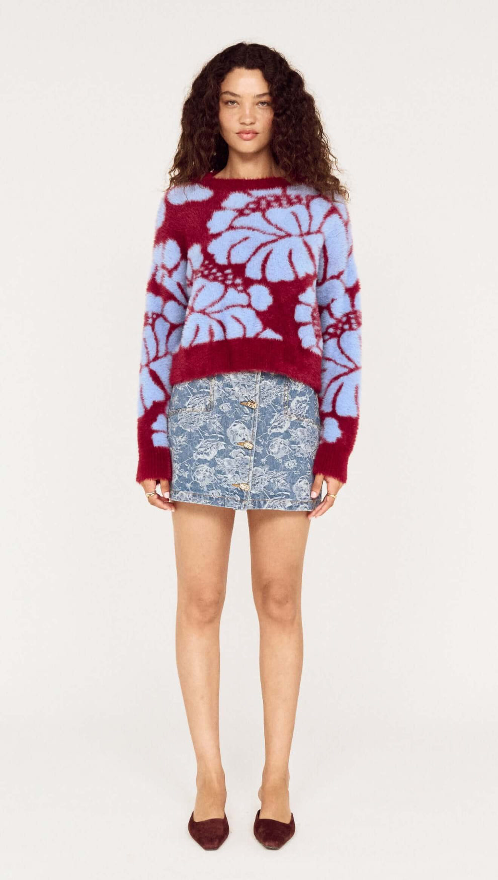 Model wearing the Intarsia Floral Soft Touch Jumper paired with a denim skirt, showcasing the vibrant floral design.