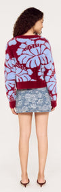 Back view of a model wearing the Intarsia Floral Soft Touch Jumper in maroon and blue with a denim skirt.