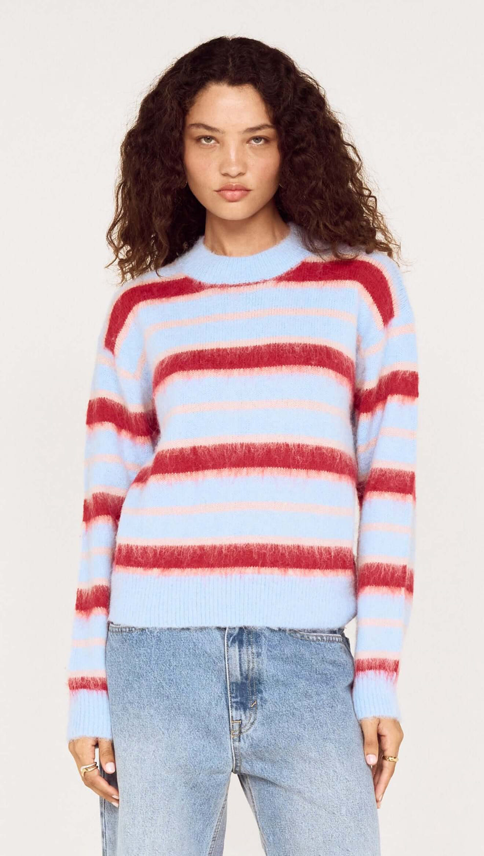 Peppermint Stripe Fluffy Jumper featuring bold red and blush stripes on a soft blue base, perfect for cool-weather style.