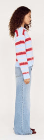Model wearing the Peppermint Stripe Fluffy Jumper with red and blush stripes on a soft blue background.