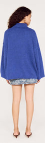 Back view of a model wearing a Blue Oversized Roll Neck Jumper, showcasing its relaxed fit and cozy design.