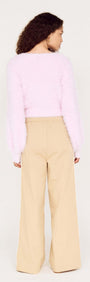 Cropped Baby Pink Fluffy Jumper paired with wide-leg beige pants, showcasing the soft texture from the back.