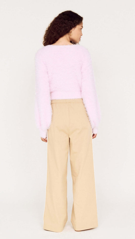 Cropped Baby Pink Fluffy Jumper paired with wide-leg beige pants, showcasing the soft texture from the back.
