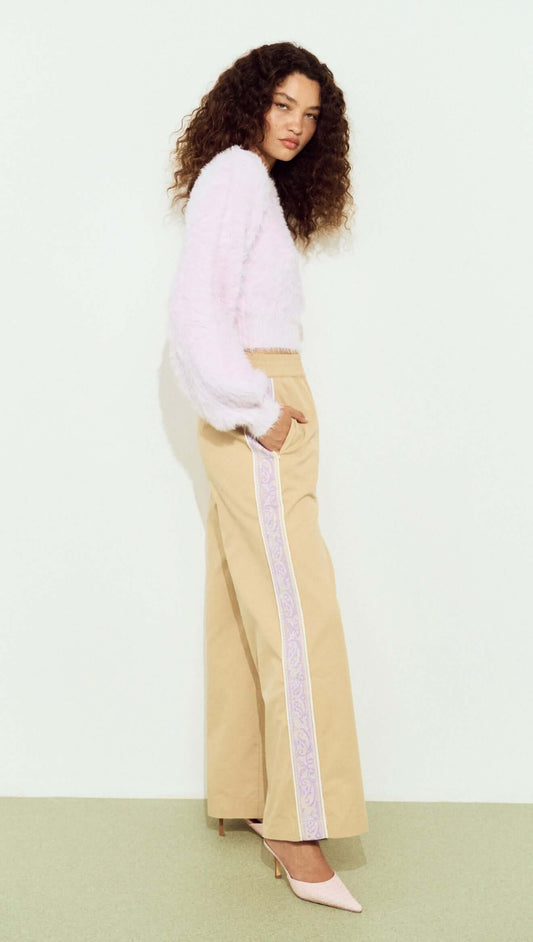 Model wearing a Cropped Baby Pink Fluffy Jumper paired with wide-leg beige trousers.